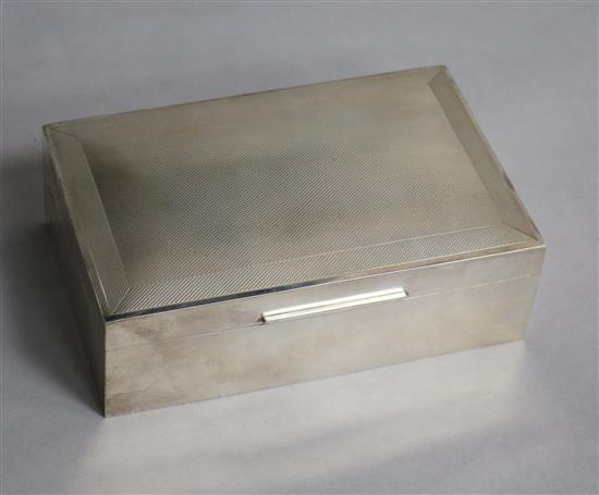 A George VI engine turned silver rectangular cigarette box, W.H. Manton Ltd, Birmingham, 1950, 14cm.